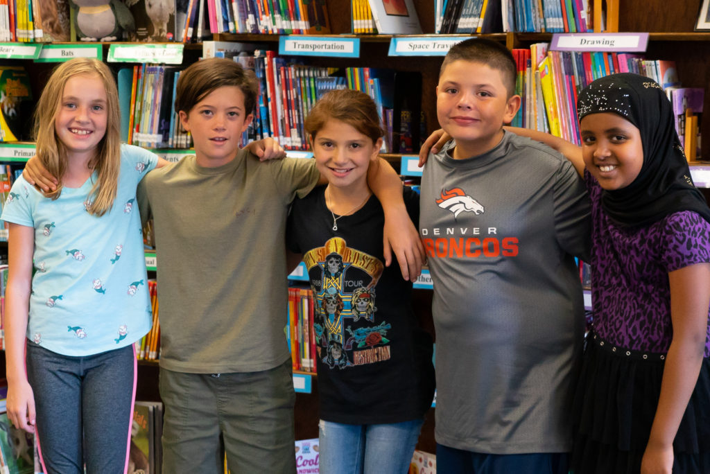 Group of students posing in the library