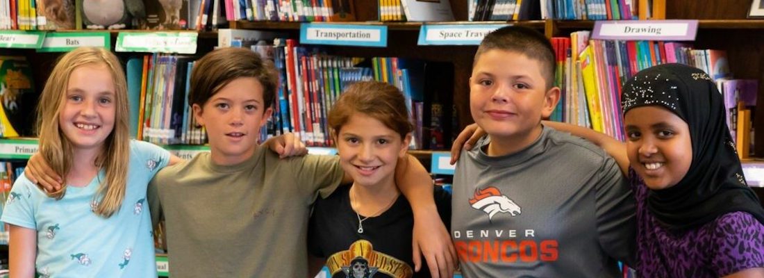 Group of students posing in the library